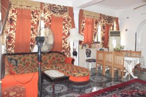 a living room filled with furniture and a fire place at Nuba Dool Guest House in Aswan