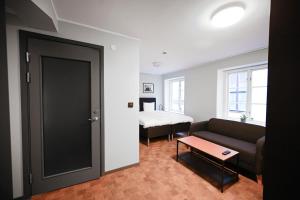 a living room with a couch and a bed at Old Town Stay Hotel in Stockholm