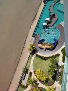 einen Blick über einen Pool neben dem Meer in der Unterkunft SEAVIEW Studio with KING BED at Imperium Residence, Kuantan in Kuantan