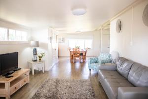 a living room with a couch and a table at Audrey Wilkinson Vineyard in Pokolbin