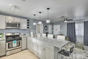 a kitchen with white cabinets and a counter top at North Las Vegas Hideaway with Grill Less Than 10 Mi to Strip in Las Vegas