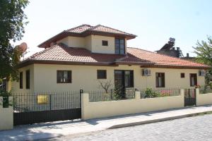 a house with a fence in front of it at Begonville Villa in Koycegiz