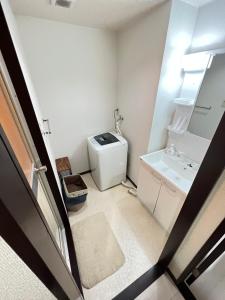 Postel nebo postele na pokoji v ubytování 五条セフィーマンション101