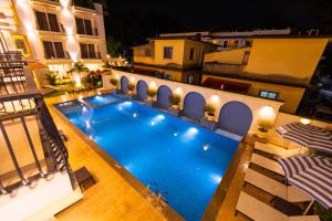 an overhead view of a swimming pool at night at Alvorada Resort-3 Star Resort In Baga in Arpora