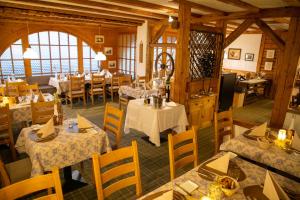 une salle à manger avec des tables et des chaises dans un restaurant dans l'établissement Alpenlodge Val Gronda, à Obersaxen