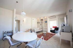 a white living room with a white table and chairs at Apartments Bedlecce in Lecce