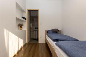 A bed or beds in a room at Takács Pince apartman
