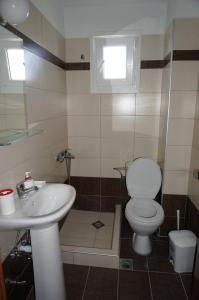a bathroom with a toilet and a sink at Kymata by Anastasia in Stavros +84 photos