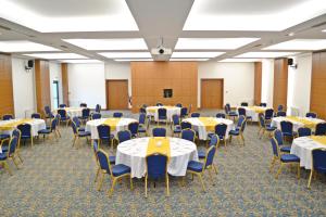 a room filled with tables and chairs with white tablecloths at TEZMADRA HOTEL in Burhaniye +40 photos