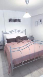 a bedroom with a large bed with a pink blanket at Lavender Home in Volos