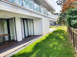 a house with a lawn in front of it at RelaxApart - Komfortowy apartament Kalinowa in Szczyrk