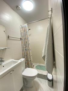 a bathroom with a toilet and a sink and a shower at Pavlov Hotel in Omsk