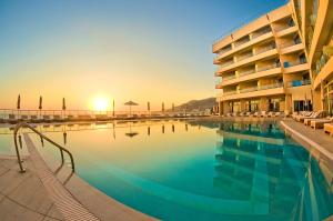 a large swimming pool in front of a hotel at Konstantinos Palace in Karpathos