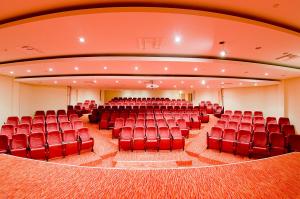 an auditorium with red chairs in a large room at Konstantinos Palace in Karpathos
