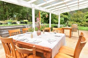 a table with plates and utensils on a patio at KiNam Vinea - A Vineyard Farmhouse in the Yarra Valley in Gladysdale