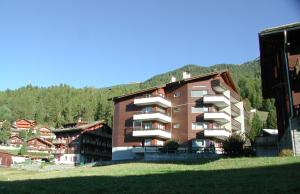 a large apartment building in front of a mountain at Brunegghorn 10 in Grächen