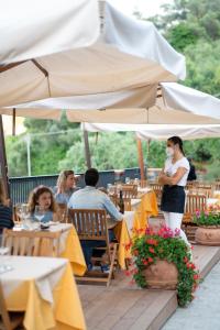 a group of people sitting at tables under umbrellas at Agriturismo Buranco in Monterosso al Mare