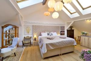 a bedroom with a large bed and a skylight at Kalina Apartments in Brno