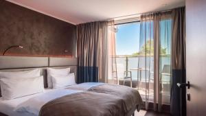 Postel nebo postele na pokoji v ubytování Innspire Hotel
