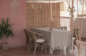 a dining room with a table and chairs at Ecoresort Hotel Zefyros in Ayios Kirikos