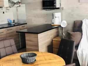 a kitchen with a stove, sink, and dishwasher at Apartamentos Pie de Pistas 3000 in Pas de la Casa