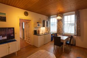 a kitchen and dining room with a table and a dining room at Gästehaus Steuer in Kröv