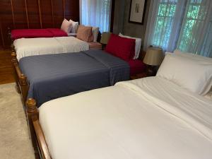 a group of four beds in a room at HomeandHomestay Chiang Kham in Chiang Kham
