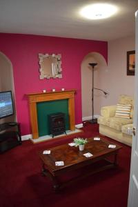 a living room with a couch and a fireplace at Great base for a Yorkshire adventure in Old Malton