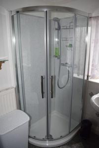 a shower with a glass door in a bathroom at Great base for a Yorkshire adventure in Old Malton