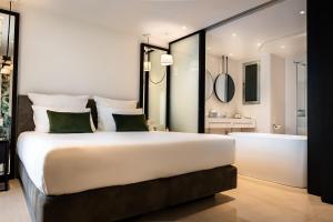 a bedroom with a large bed and a bath tub at Hotel Valentina in St. Julianʼs