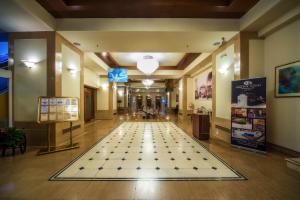 a hallway with a checkerboard floor in a building at Capsis Hotel Thessaloniki in Thessaloniki
