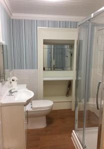 a bathroom with a toilet and a sink and a shower at Eden Vale First Floor Sea View Apartment in Morecambe