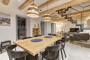 a dining room with a wooden table and chairs at Casa Santa Maria Vacation House in Mali Lošinj