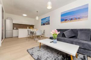 a living room with a couch and a table at Apartments Villa Niko in Trogir