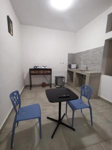 sala de estar con 2 sillas azules y mesa en Résidence Maty - 2 chambres salon en Grand Médina