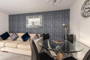 a living room with a glass table and a couch at Tudhoe View in Spennymoor