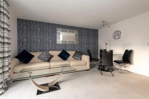 a living room with a couch and a table at Tudhoe View in Spennymoor