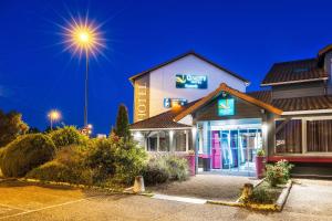 a view of a mobil gas station at night at Quality Hotel Clermont Kennedy in Clermont-Ferrand