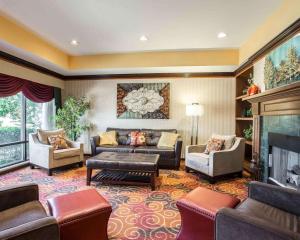 a large living room with couches and a fireplace at Comfort Inn & Suites at I-85 in Spartanburg
