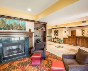 a living room with a fireplace and couches at Comfort Inn & Suites at I-85 in Spartanburg