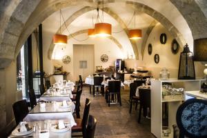 a restaurant with tables and chairs in a room at Marquis de la Baume in Nîmes