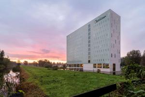a rendering of a building with a field in front of it at Radisson Hotel & Suites Amsterdam South in Amstelveen