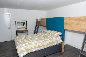 a bedroom with a bunk bed and a ladder at Weston Lawns Lodges in Bulkington