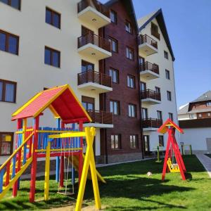 a playground in front of a apartment building at Apartment Stefan in Vila Katalina Lux in Zlatibor