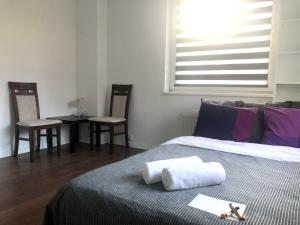 ヴロツワフにあるBlue River - ul Ciepla - near PKP and aquaparkのベッドルーム1室(ベッド1台、椅子2脚、テーブル付) +16枚の写真