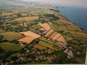 an aerial view of a village next to the water at Ottery Tor in Stokeinteignhead