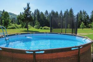 een groot zwembad met een hek eromheen bij Family Friendly Kraševec Lodge - Happy Rentals in Velike Bloke