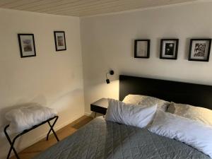a bedroom with a bed and a table and pictures on the wall at Hexenhäuschen Wankendorf in Wankendorf