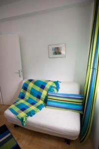 a room with a couch with a blanket on it at Apartment Andrea in Trebinje