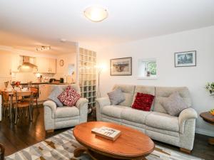 a living room with two couches and a table at The Bothy in Stonehaven